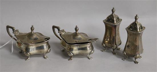 A George V silver four piece condiment set by Walker & Hall, Birmingham, 1921 and three associated spoons.